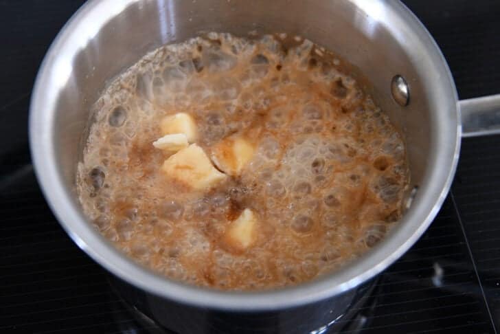 Saucepan with sugar and water mixture, butter, and cream.