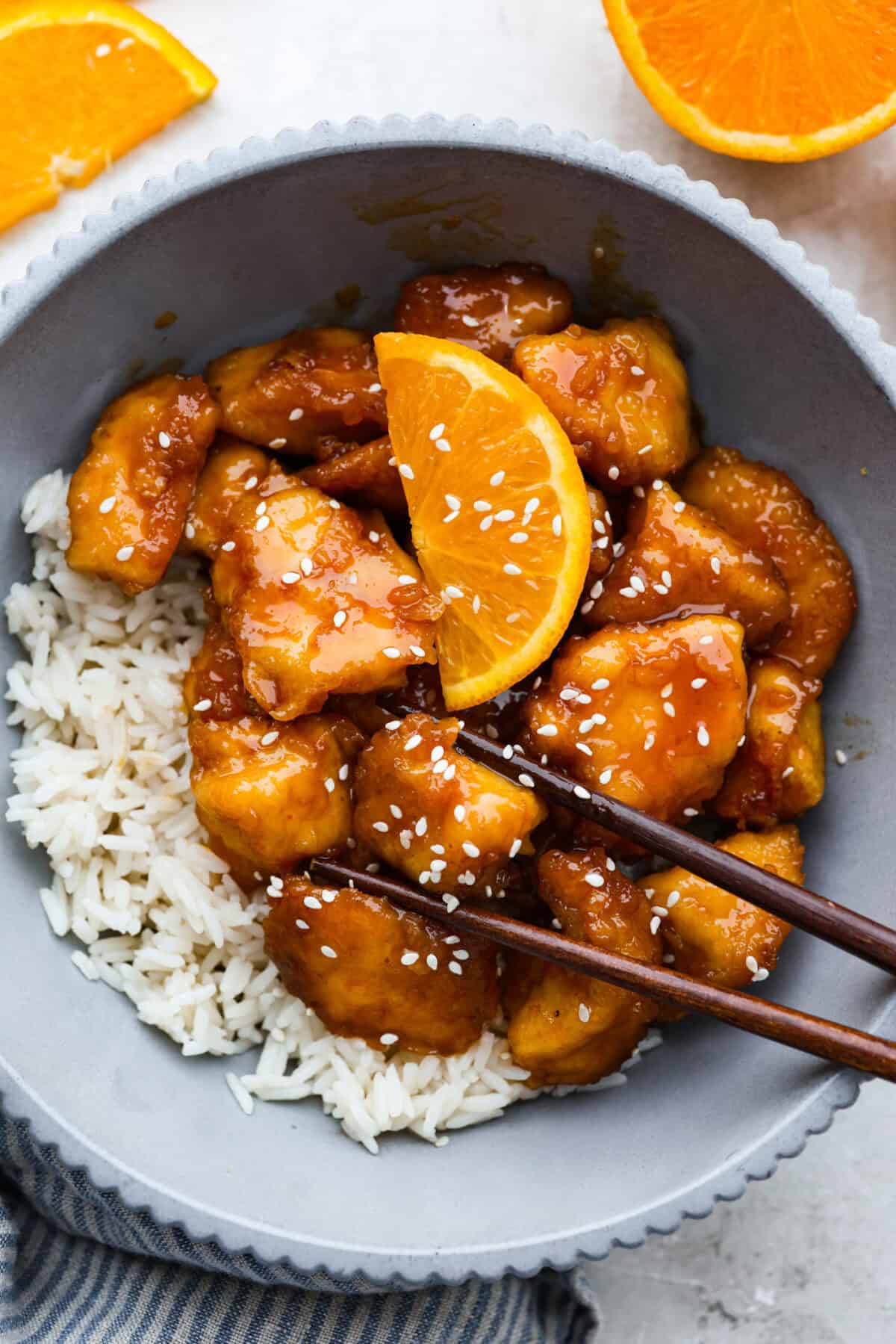 Bowl of rice and baked orange chicken. 