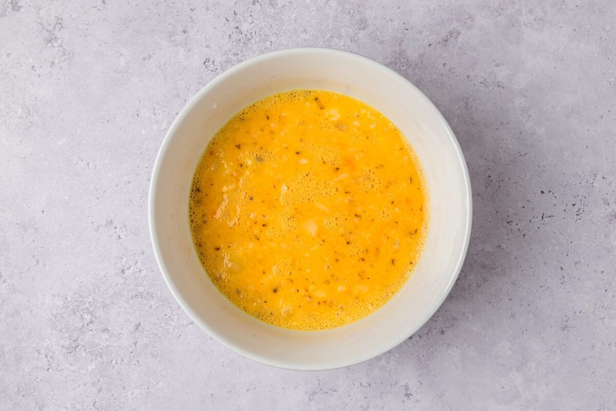 eggs, milk, melted butter, salt, and pepper whisked together in a large bowl