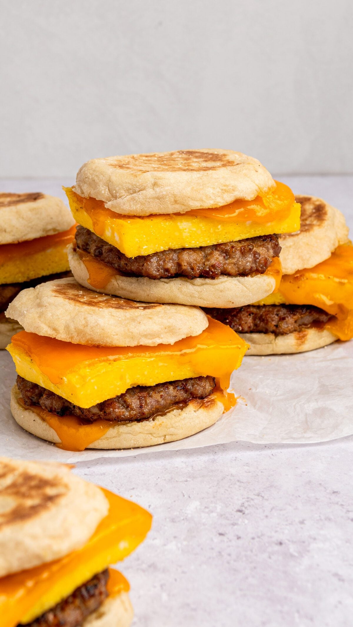 Stack of fully prepared egg sandwiches on parchment paper