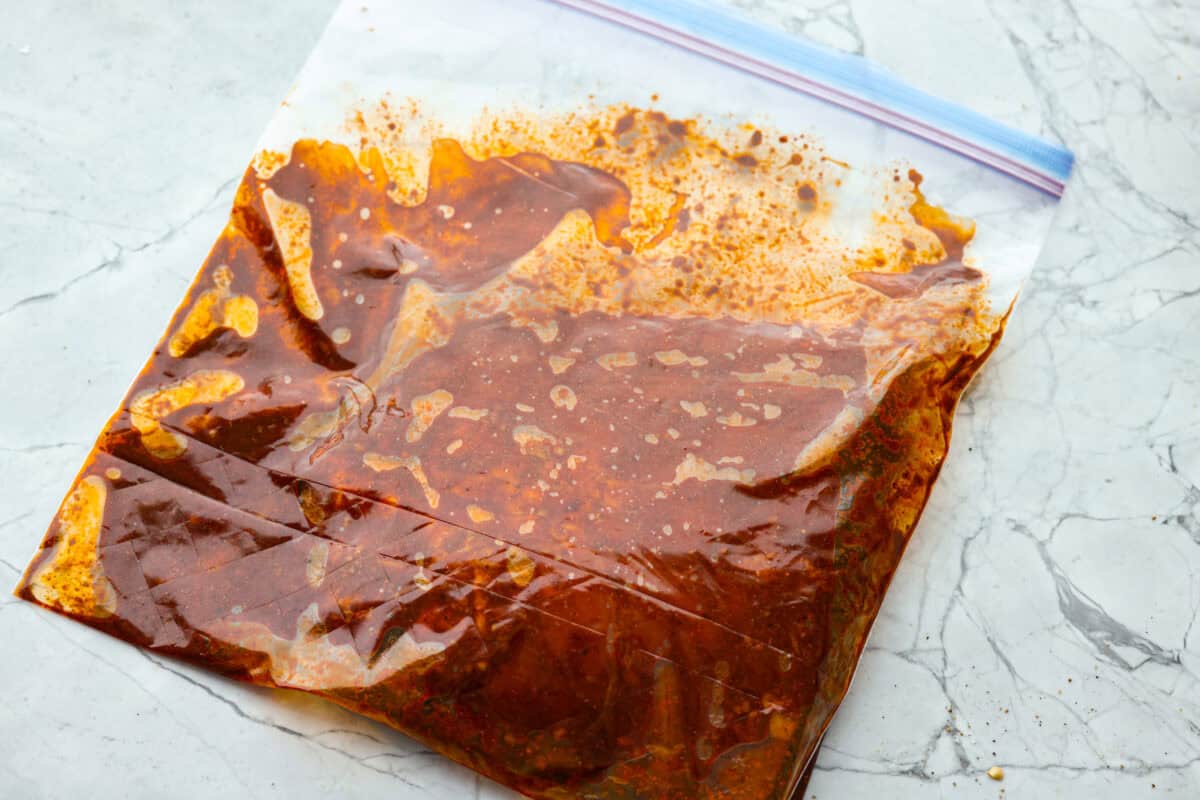Flank steak in the marinade in a zip lock bag.