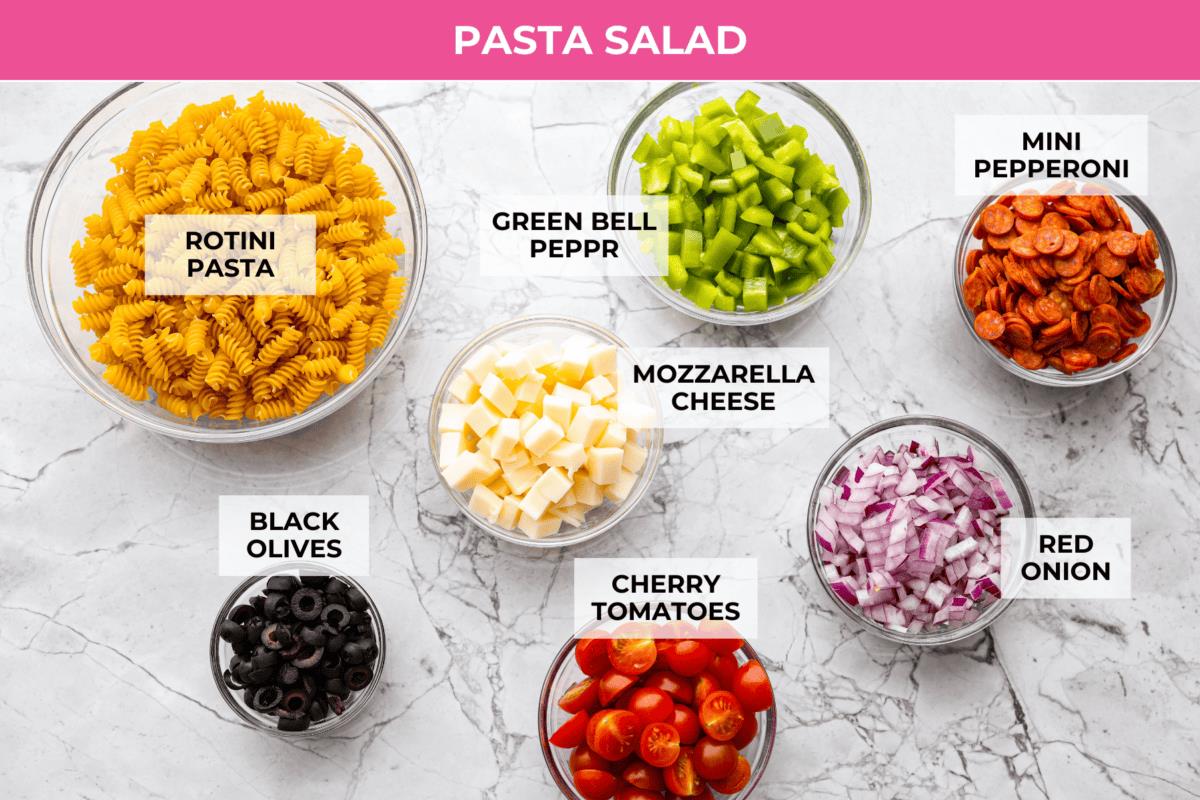 Overhead shot of labeled pasta salad ingredients. 