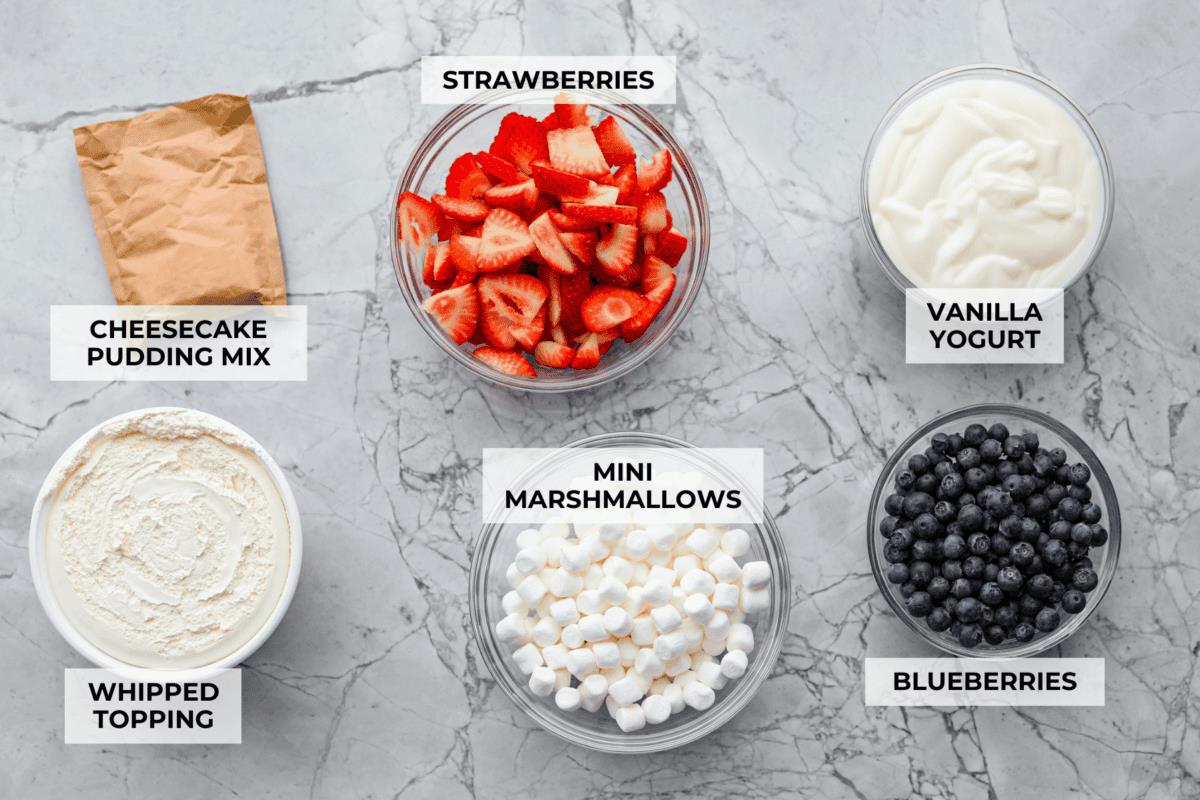 Overhead shot of labeled red white and blue cheesecake salad ingredients. 