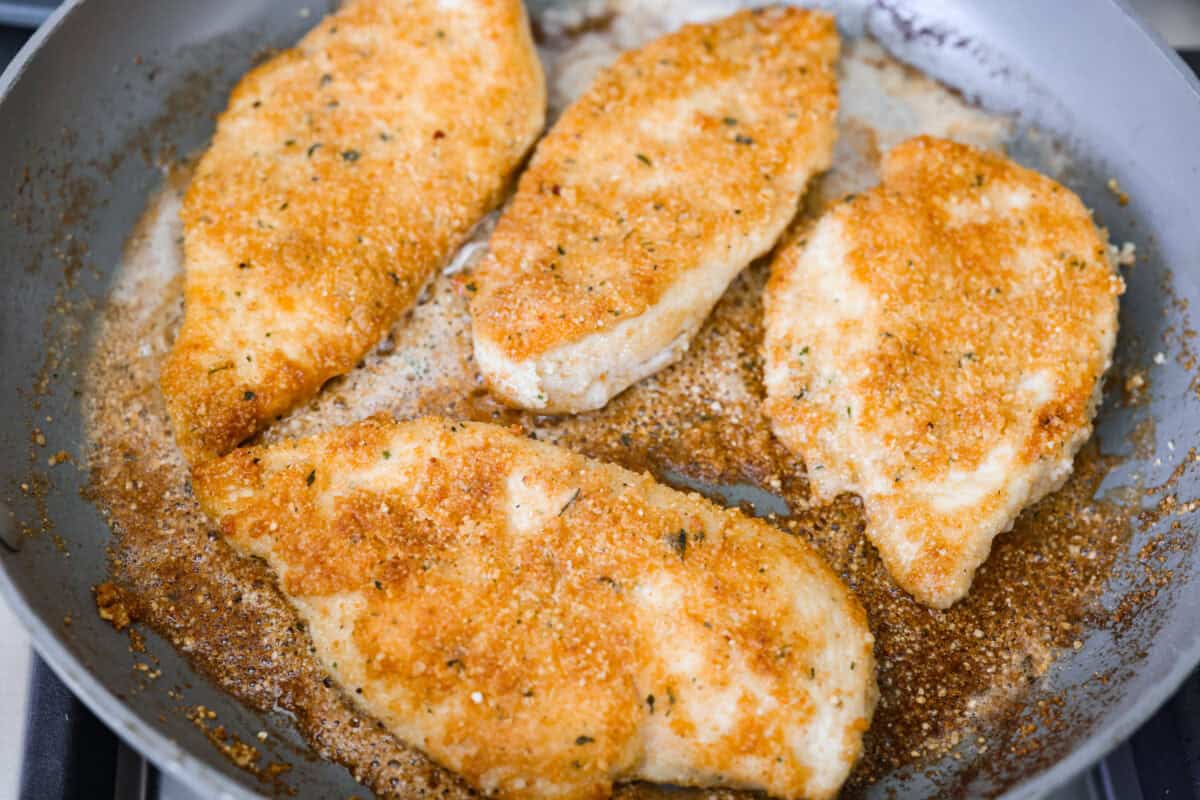 Chicken cooking in a skillet. 