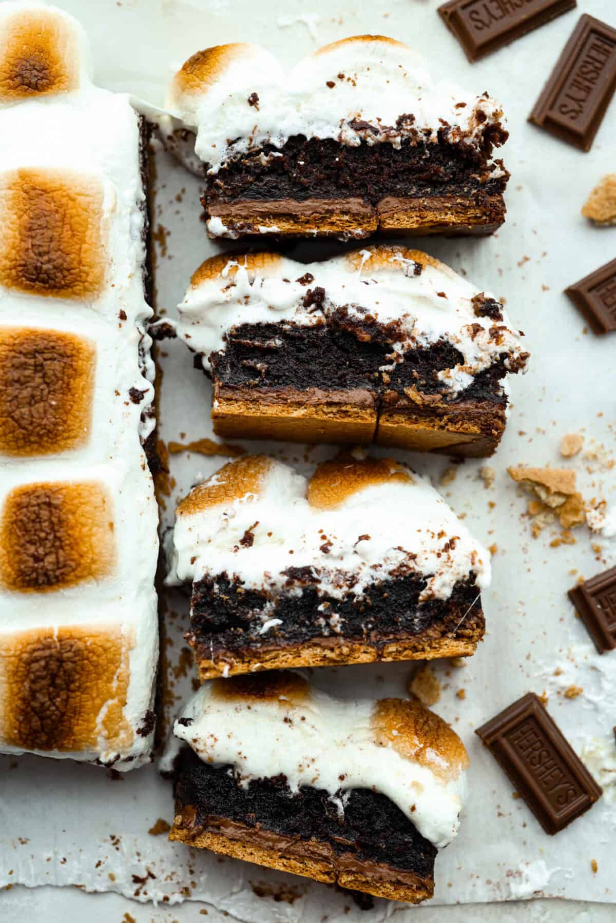Overhead shot of slices of S'mores brownies on their side so you can see all of the gooey layers. 