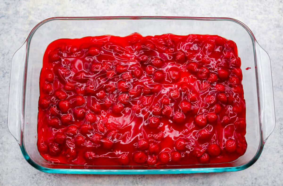 Cherry pie filling poured over the top of the cheesecake layer.