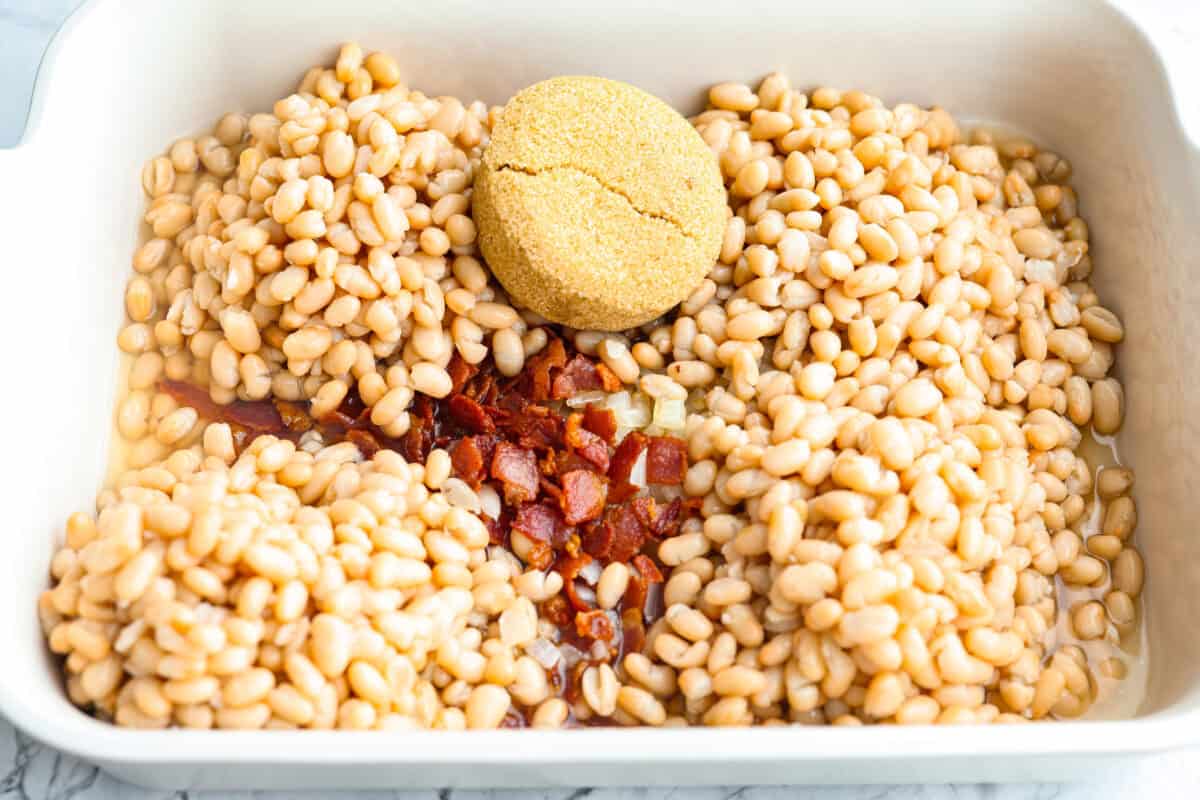 Beans, bacon, onions and sugar added to the baking dish. 