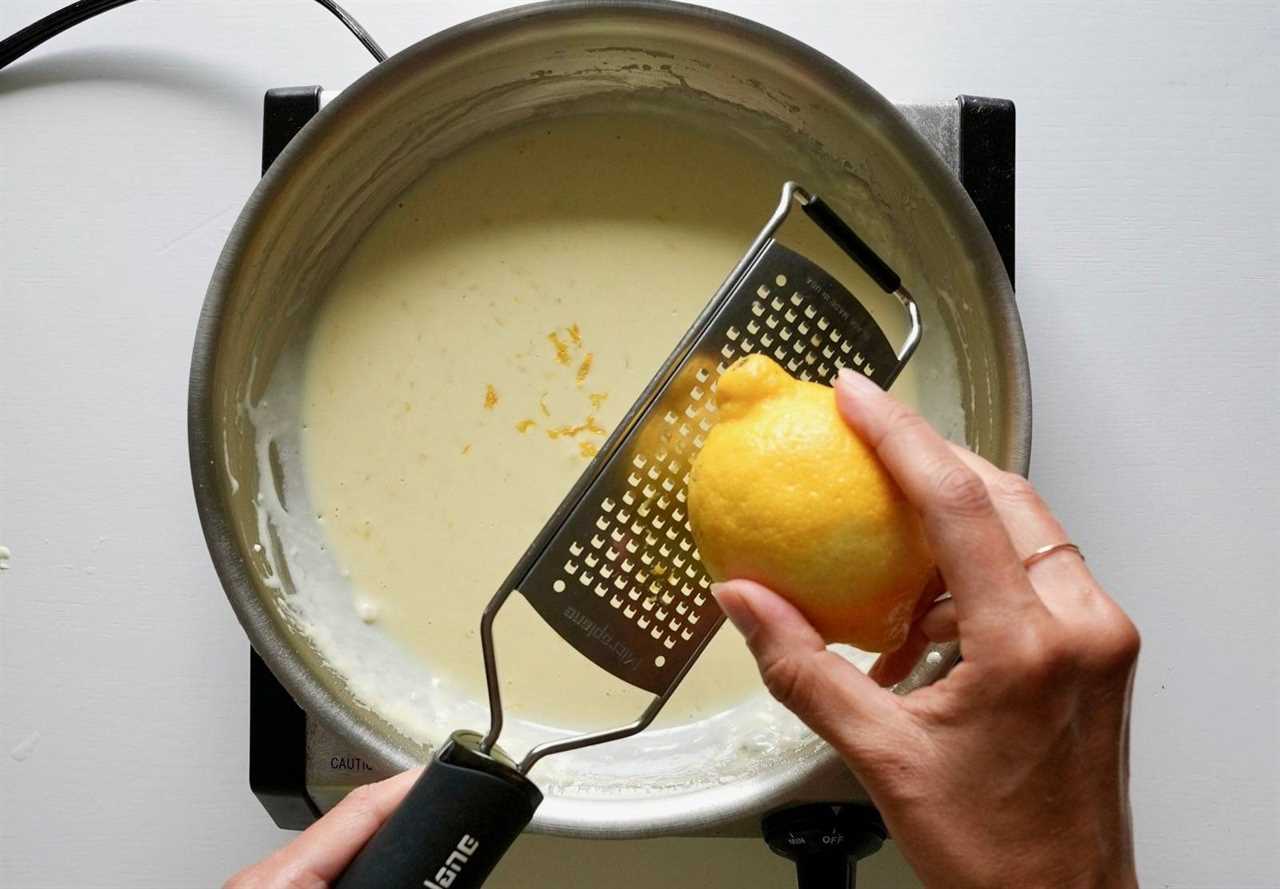 Zesting lemon into sauce.