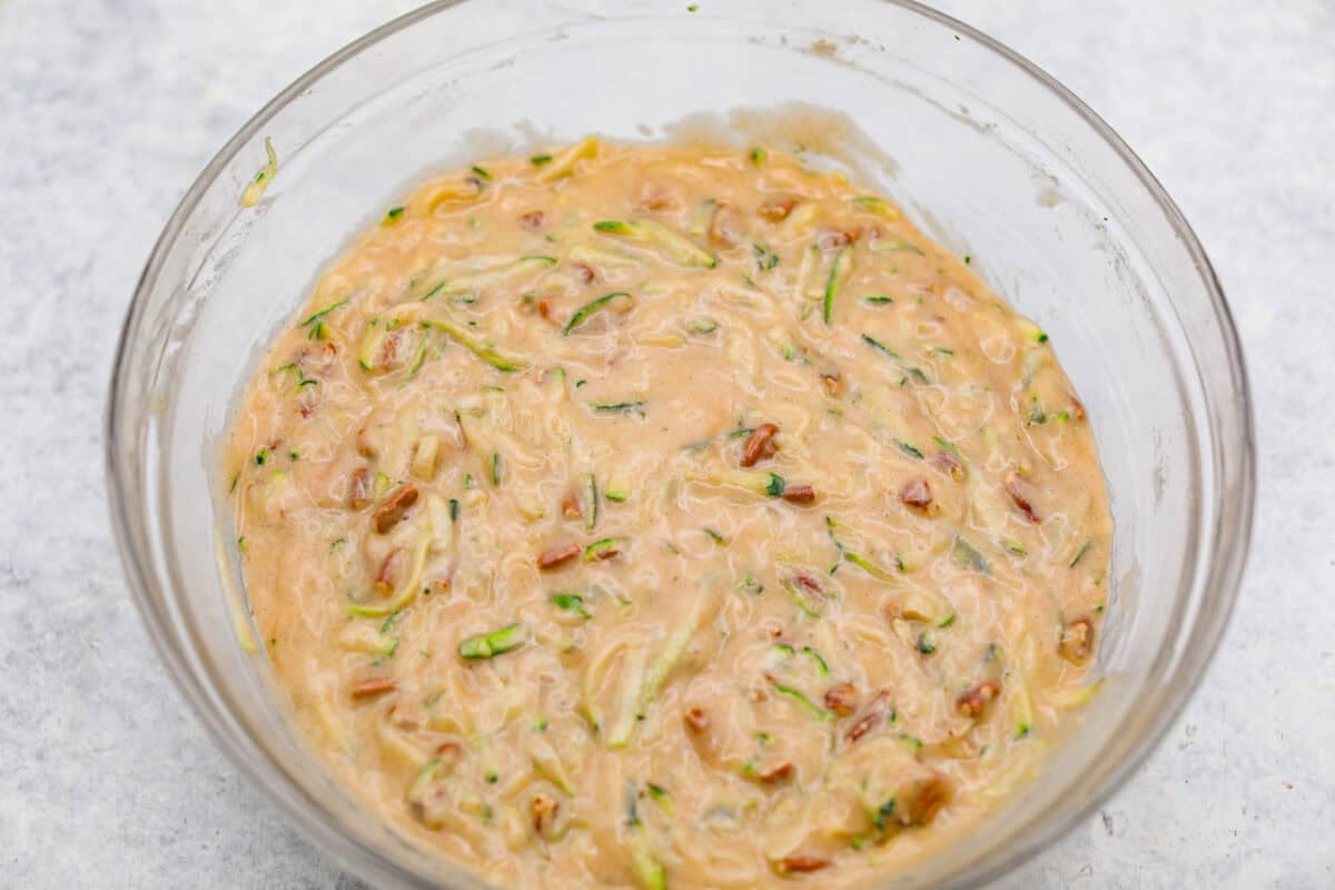 Dry and wet ingredients combined with zucchini shreds and pecans mixed in. 