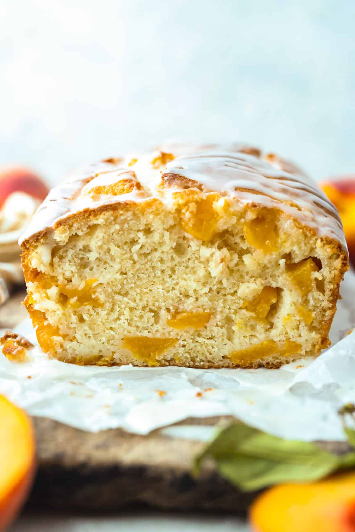 Side shot of the peach loaf on a cutting board. 