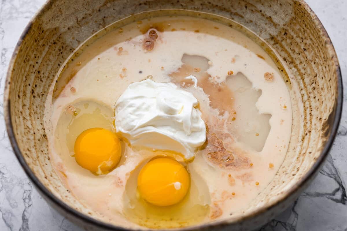Wet ingredients added to a mixing bowl. 