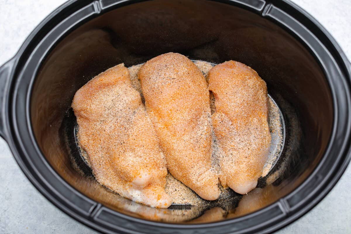 Chicken breasts seasoned in. the bottom of the crockpot. 