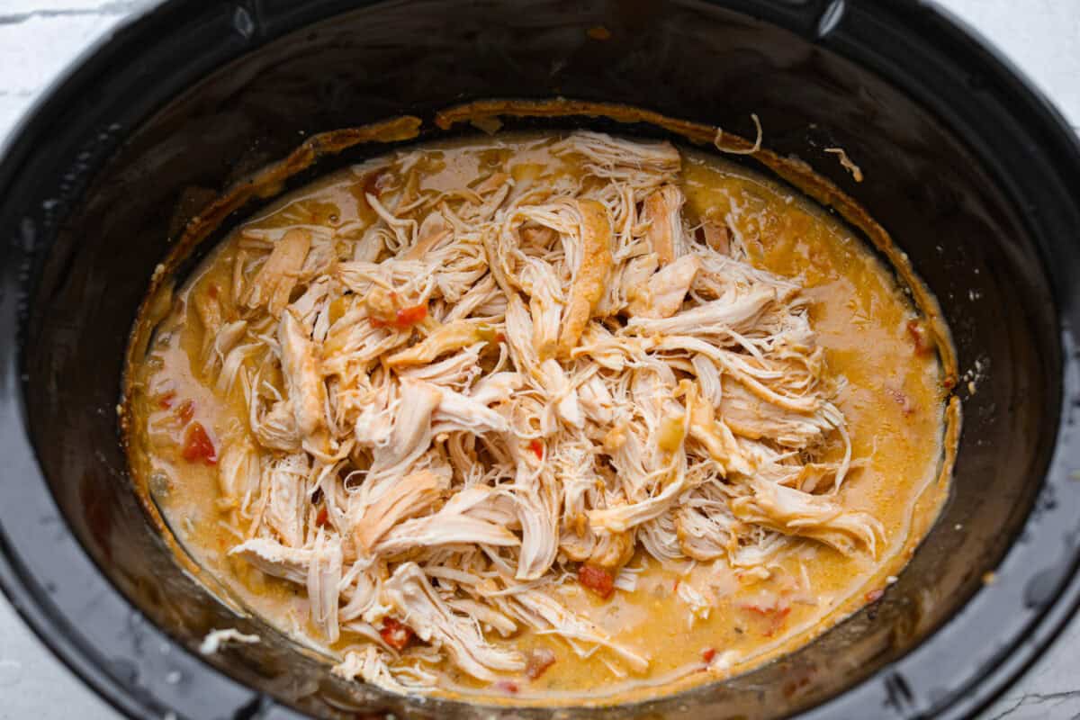 Cooked chicken shredded in the sauce. 