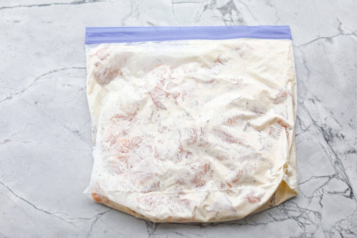 Chicken marinating in a ziplock bag.