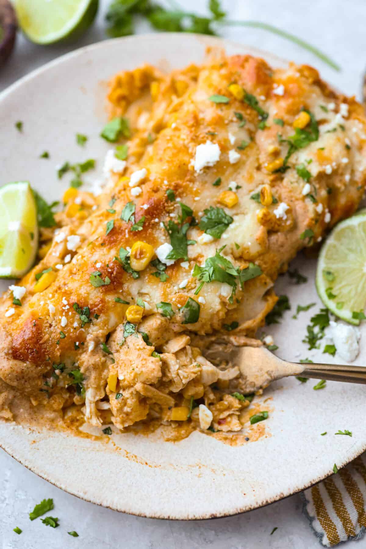 Plated street corn enchiladas.