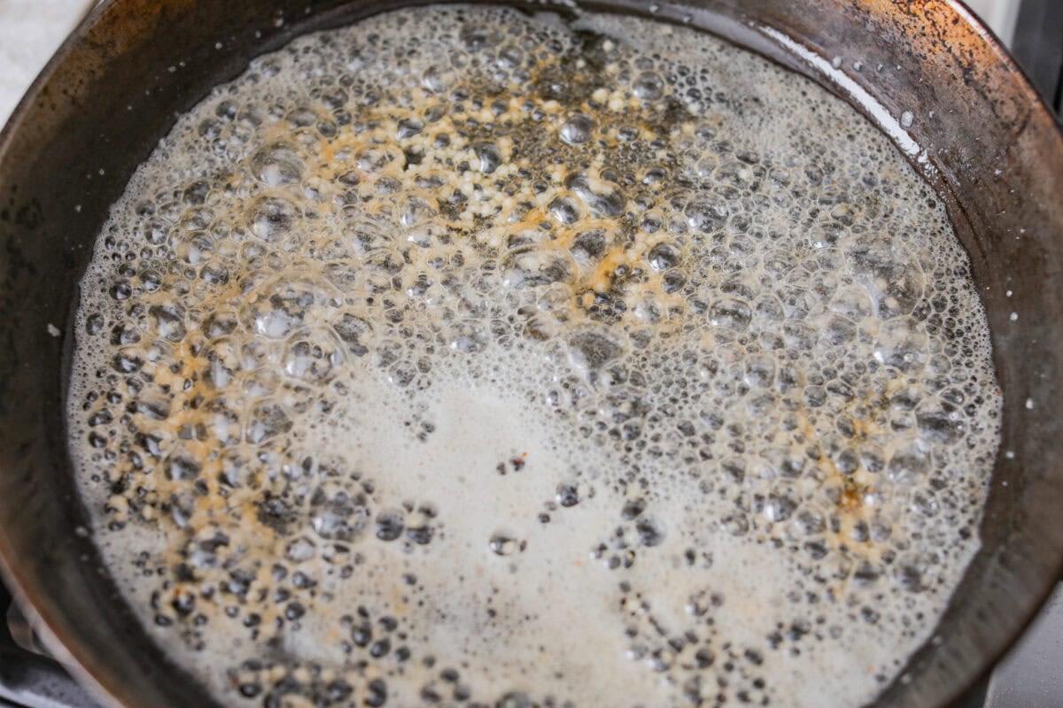 Butter cooking in a skillet. 