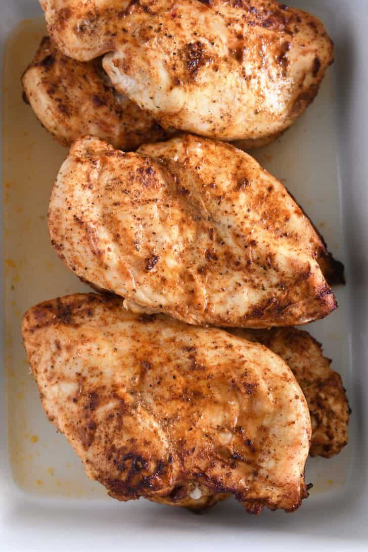Cooked chicken breasts covered in fajita seasoning.