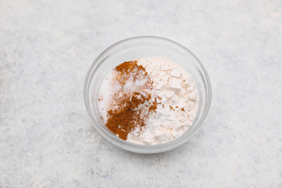 Dry ingredients added to a mixing bowl. 