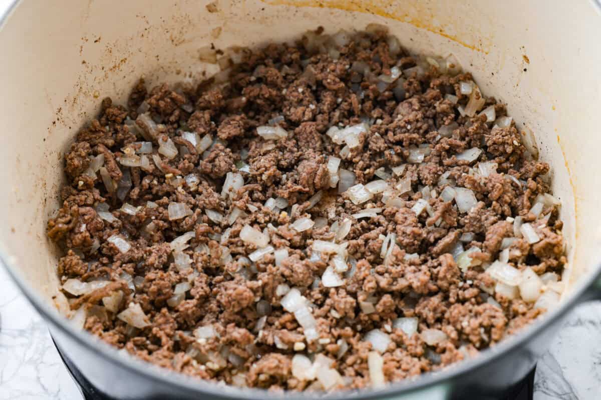 Ground beef and onions cooking in a pot. 