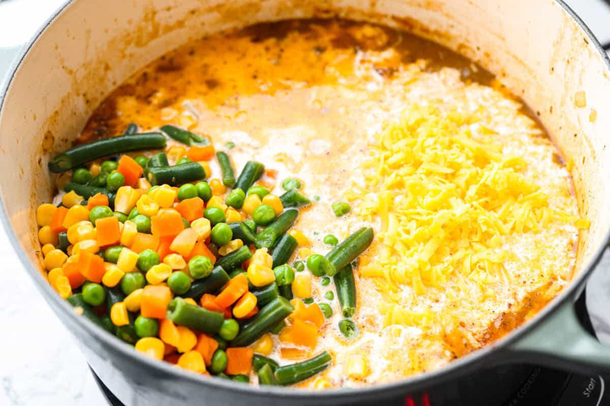 Cream, veggies, and cheese added to the pot. 