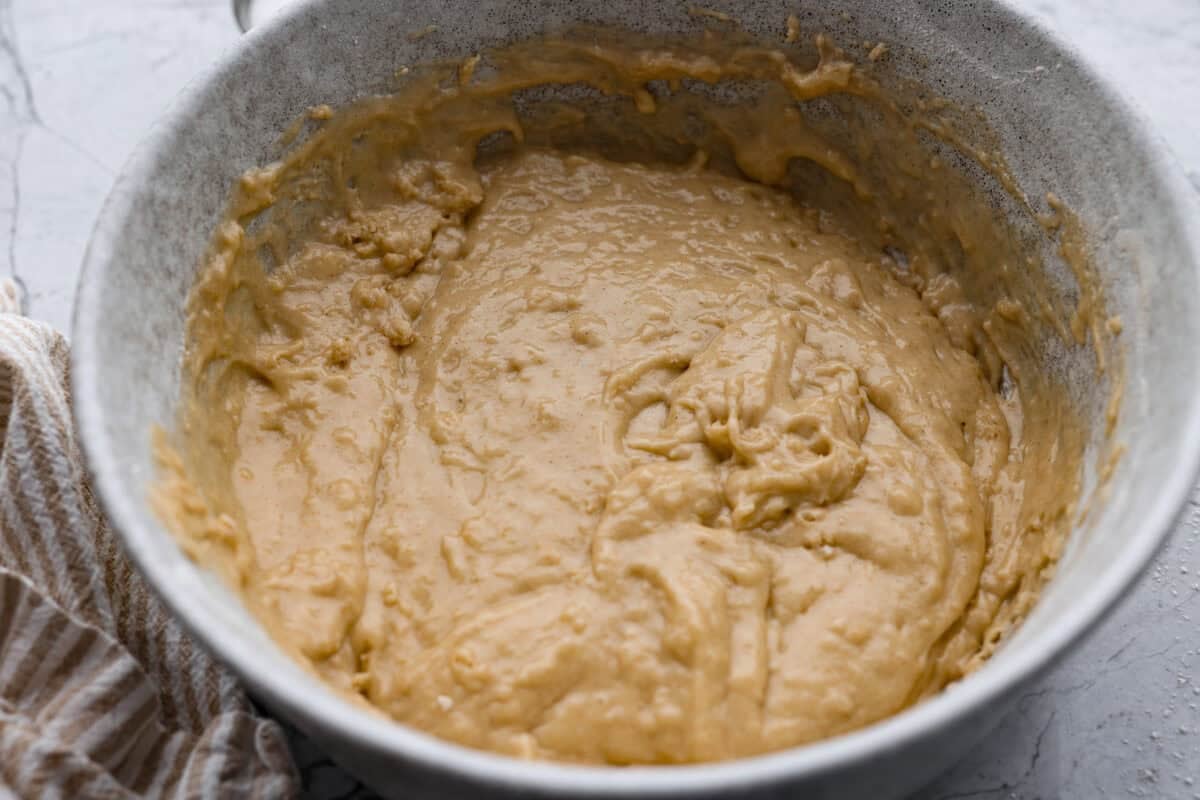 Wet and dry ingredients combined together in a bowl. 