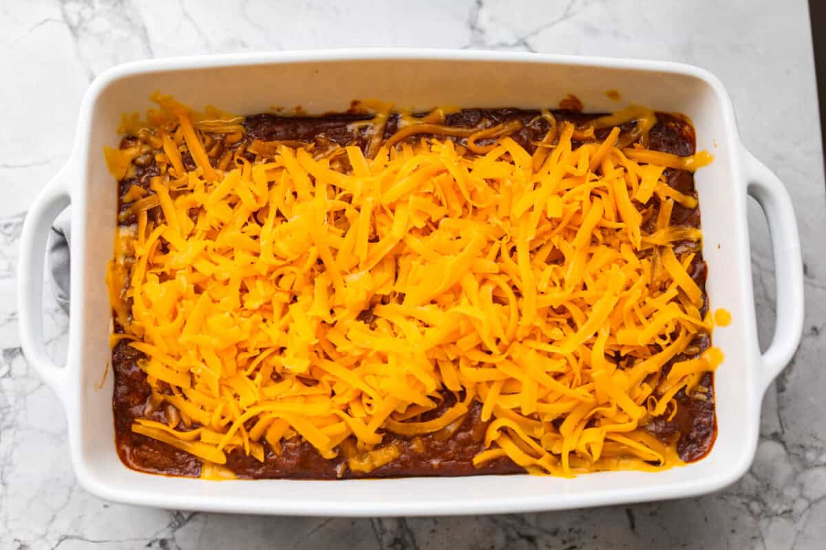 Shredded cheddar cheese added to the top of the par baked cream cheese and chili. 