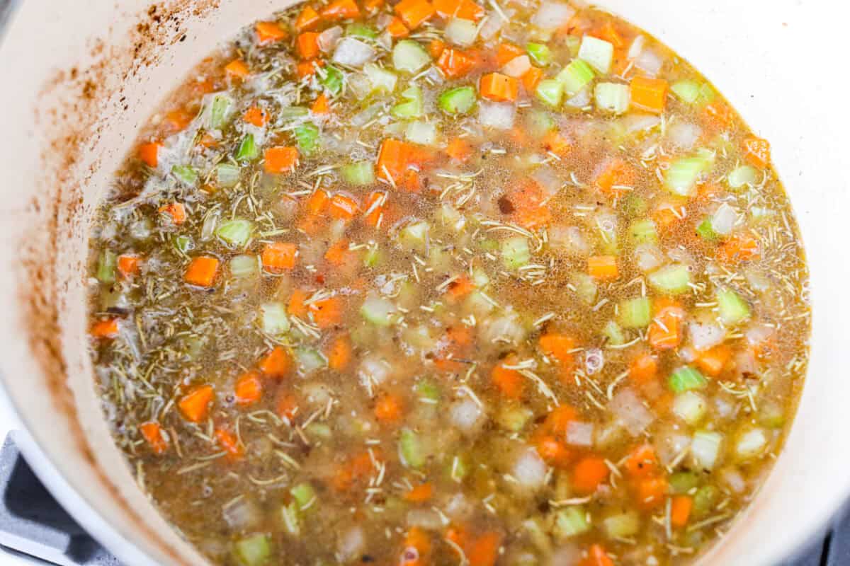 Seasonings and white wine added to the pot to deglaze it. 