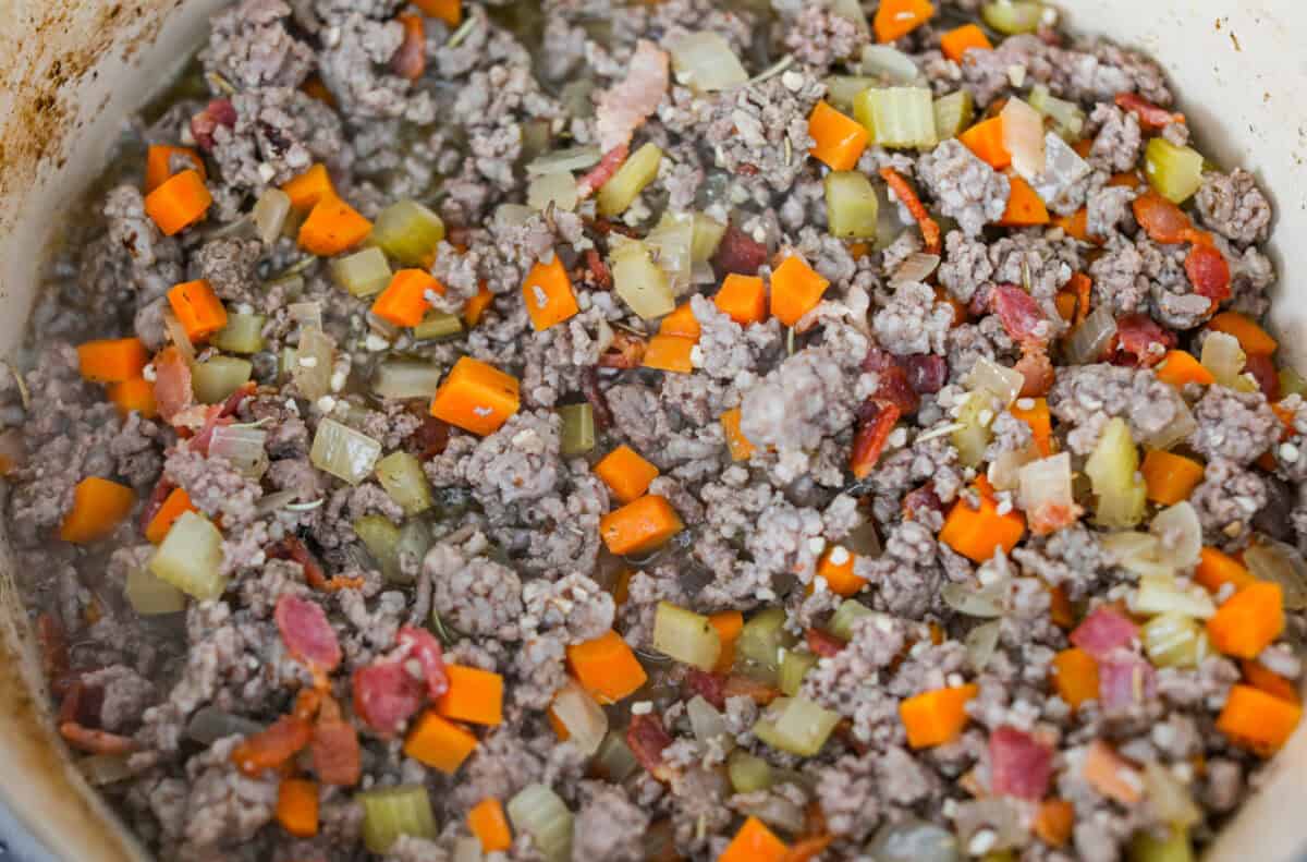 Browned meat and cooked bacon added to the pot. 