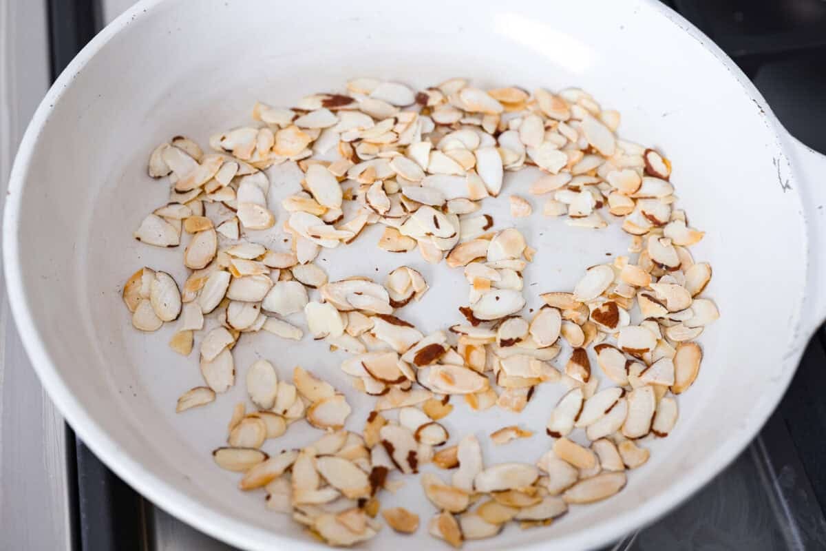 Almonds cooking in a skillet. 
