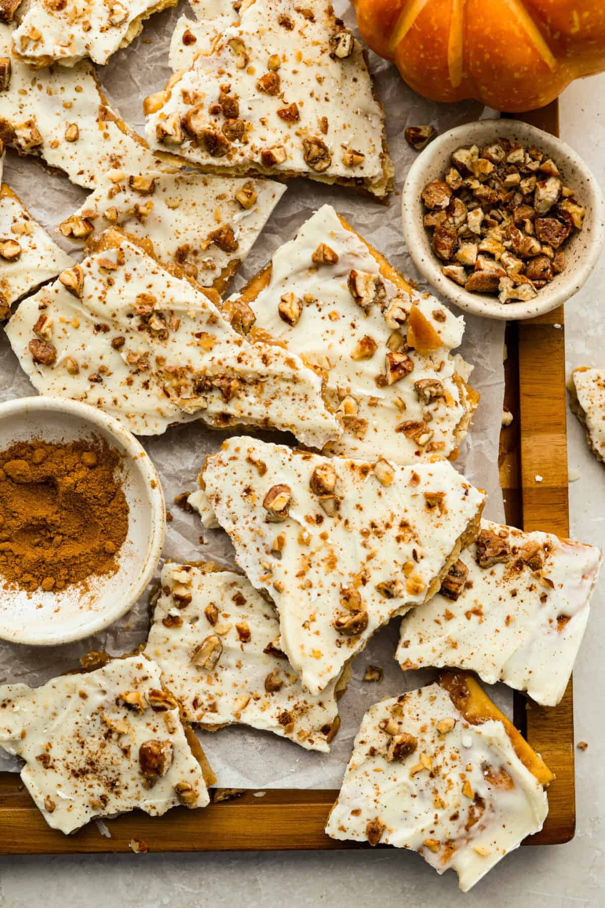 Top down shot of pumpkin pie spice crack broken up on a cutting board. 