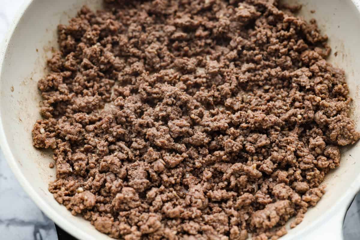 Skillet with ground beef browning in it. 