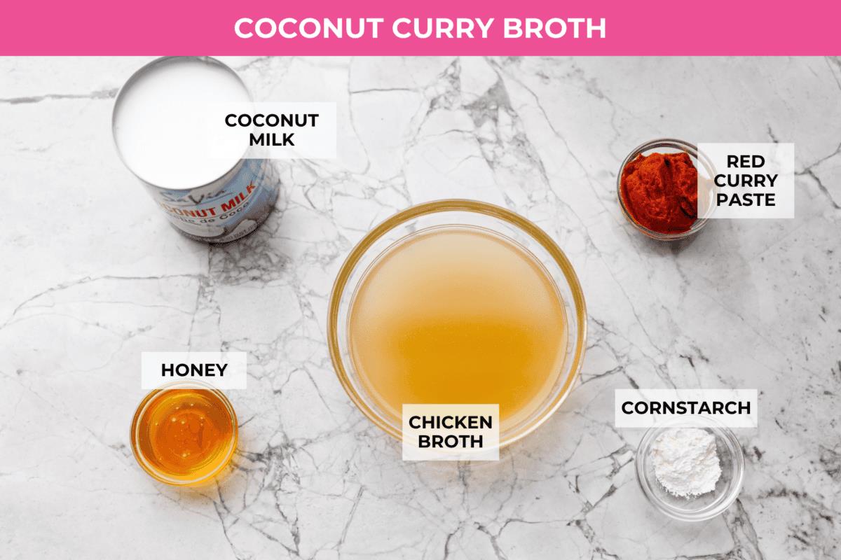 Overhead shot of labeled coconut curry broth ingredients. 