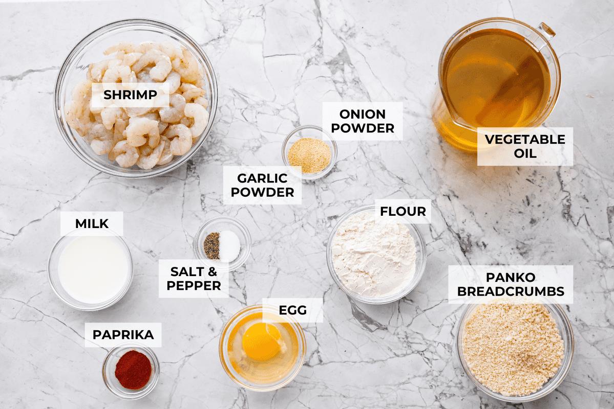 Overhead shot of labeled crispy popcorn shrimp ingredients. 