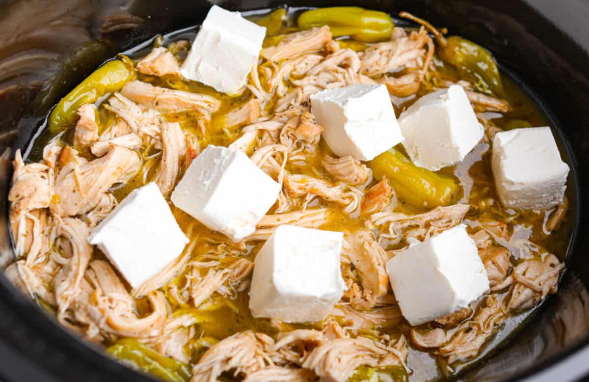 Cream Cheese added to the top of the shredded cooked chicken. 