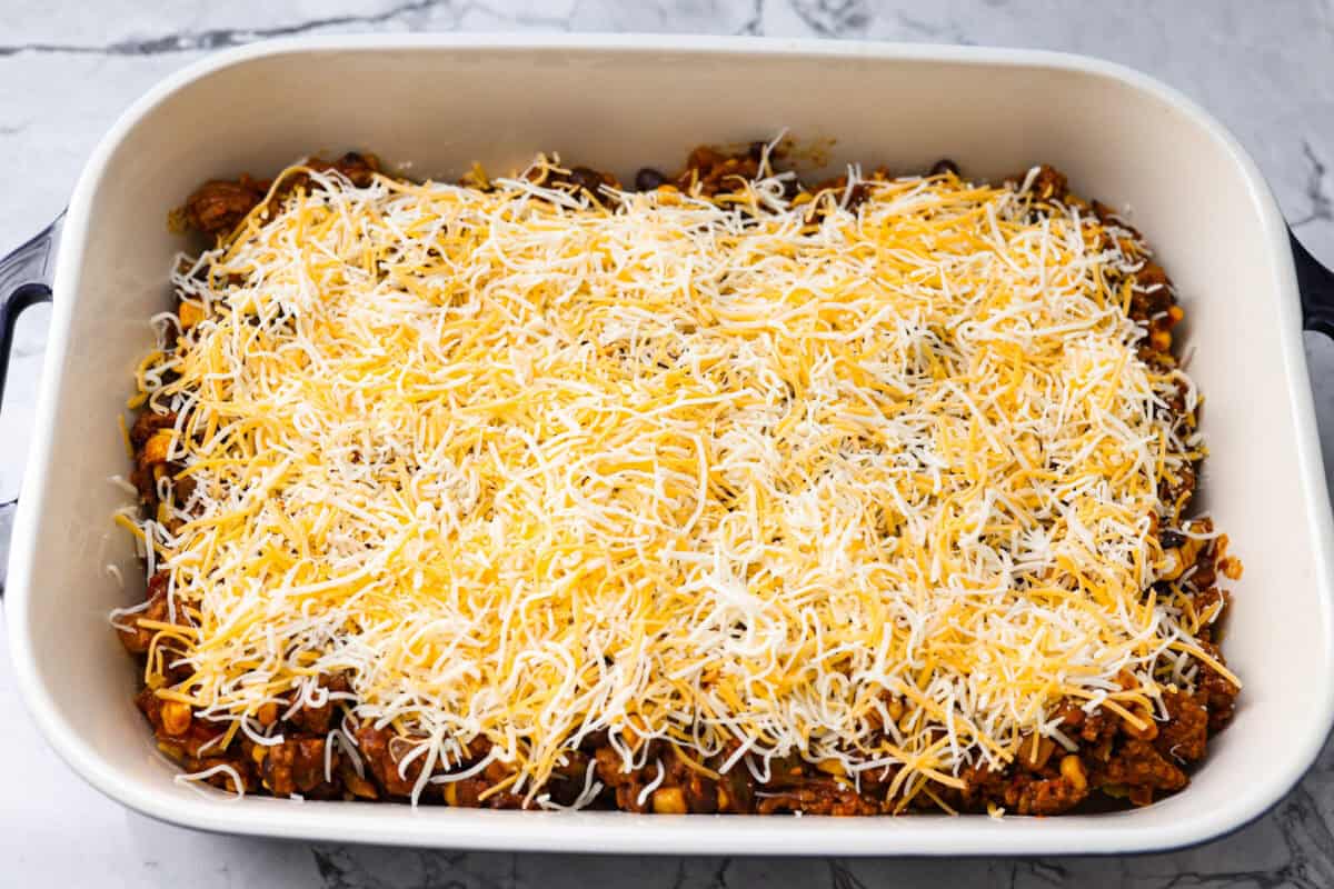 Meat mixture added to the top of the chips then topped with cheese. 