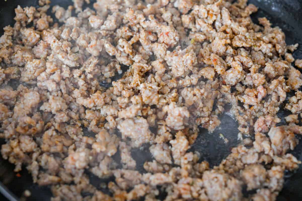 Sausage cooking in a skillet.