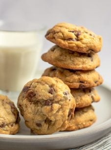 chocolate chip oatmeal cookies on plate with glass of milk