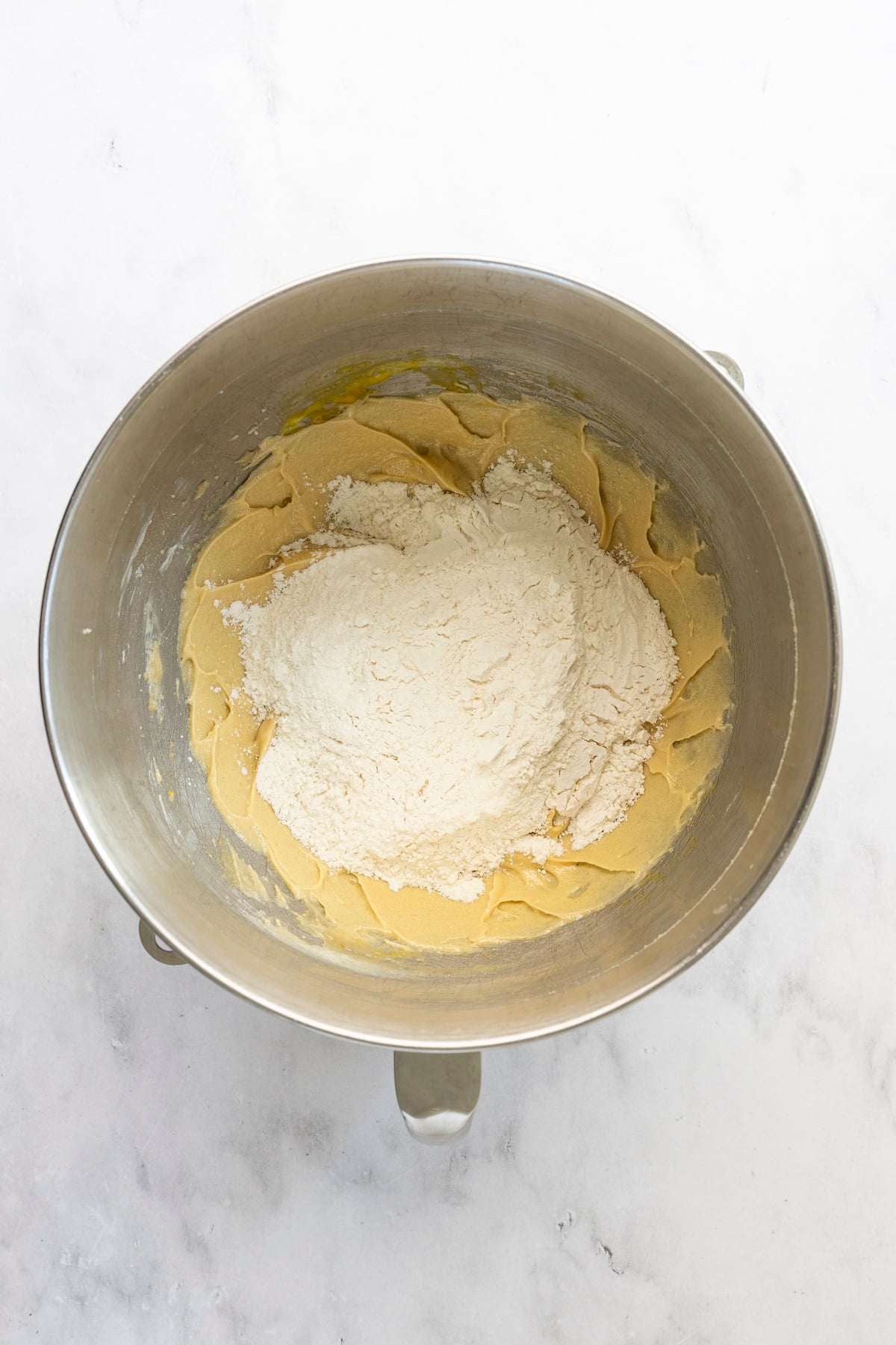 flour mixture added to mixing bowl with wet ingredients 