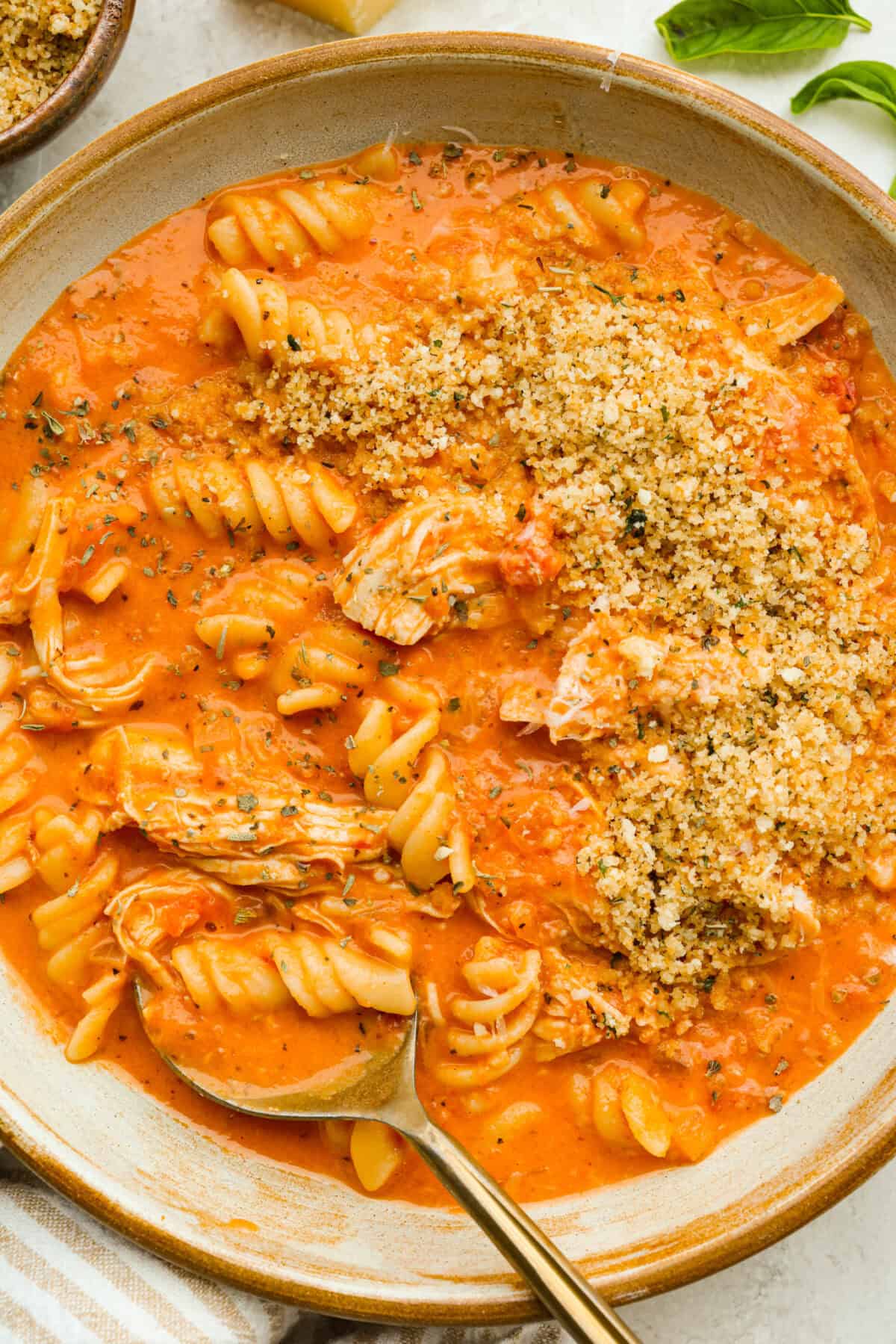Bowl of chicken parmesan sou with crispy breadcrumb topping. 