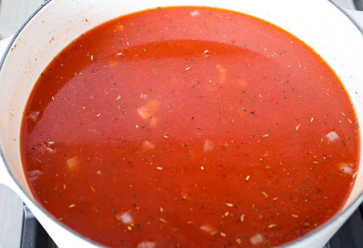 Crushed tomatoes and tomatoes sauce added to the pot with the onion mixture. 
