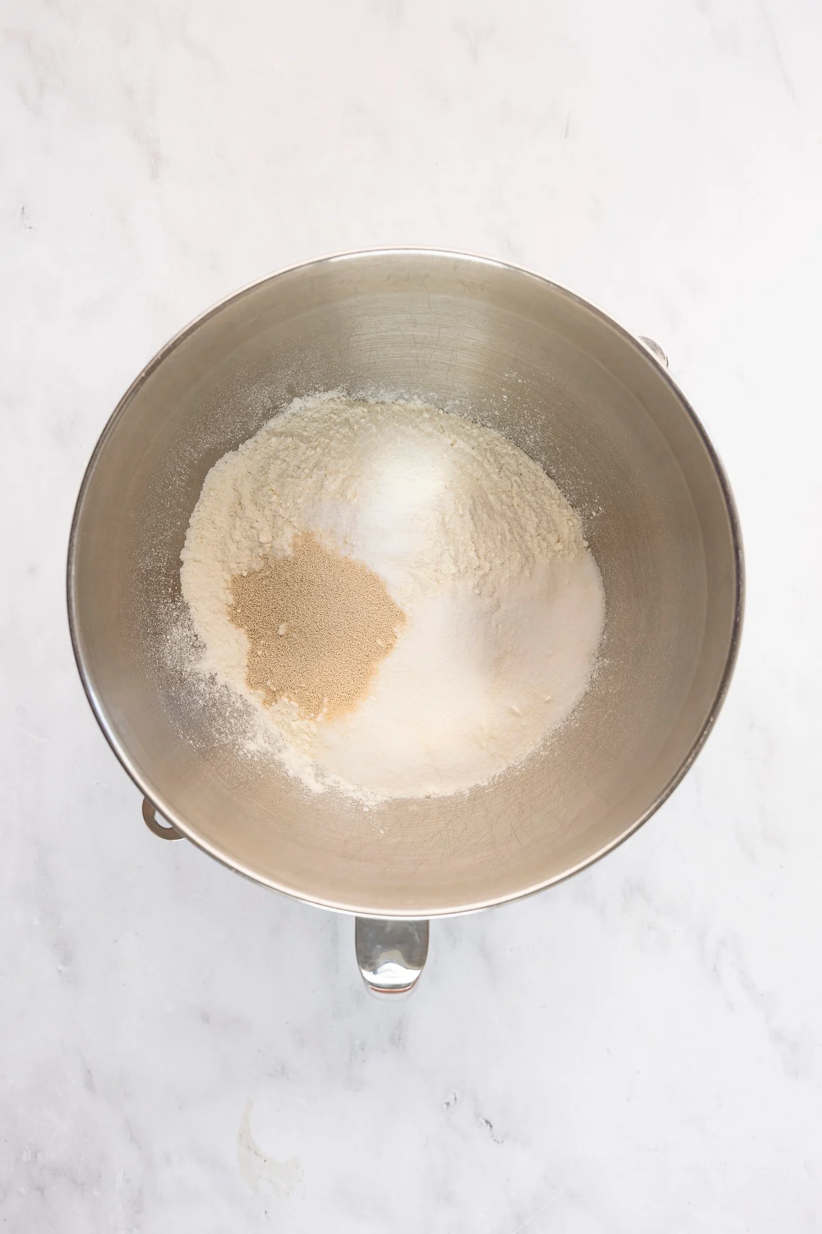 mixing bowl with flour, salt, sugar, and yeast