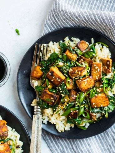 Easy Sesame Tofu Stir Fry. Crispy tofu with spinach, broccoli, or any fresh vegetables you love. This vegan recipe is packed with flavor in a simple, delicious Asian garlic ginger sauce. Serve with rice or noodles.
